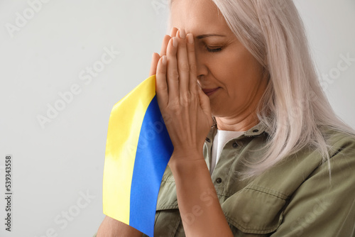Mature woman with flag of U...