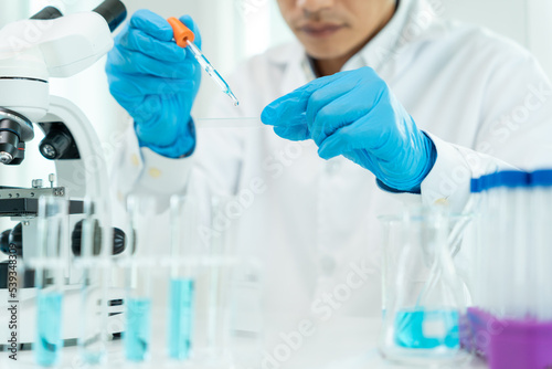 Scientist analyze biochemical samples in advanced scientific laboratory. Medical professional use dropper mix microbiological developmental of viral. Biotechnology research in  science lab.