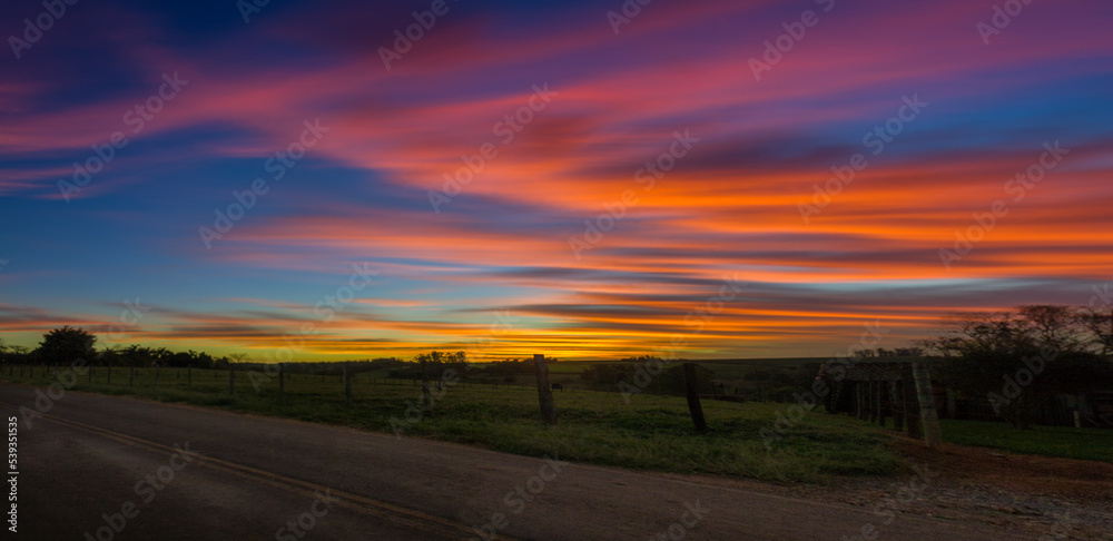 panoramic and colorful sunset over the field with long exposure