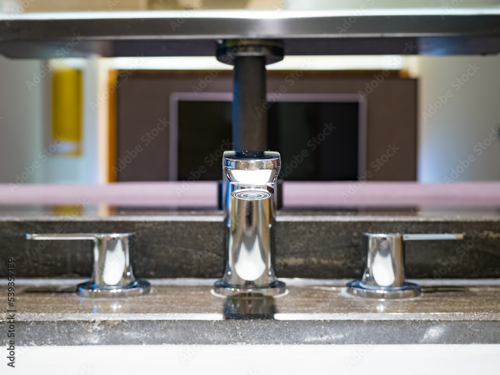Interior of bathroom with washbasin and faucet. Interior of bathroom with washbasin and faucet.