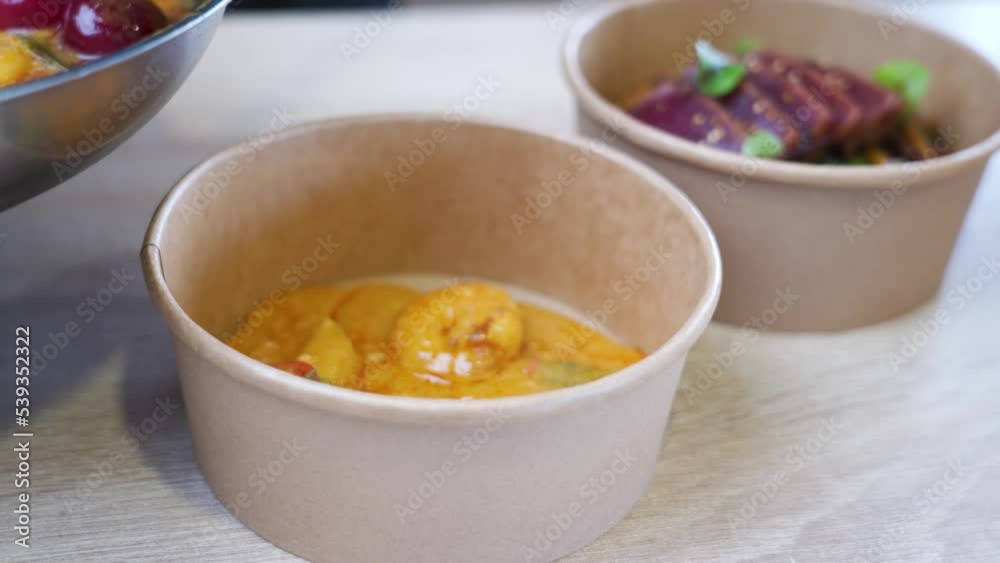 Putting Panang curry in delivery package in an Asian restaurant. Putting Panang curry in delivery package in an Asian restaurant.