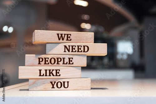Wooden blocks with words 'We Need People Like You'.
