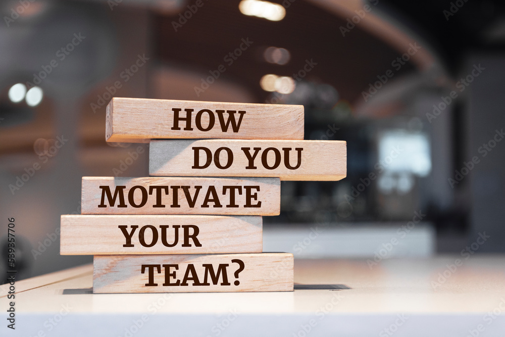 Wooden blocks with words 'How Do You Motivate Your Team?'.
