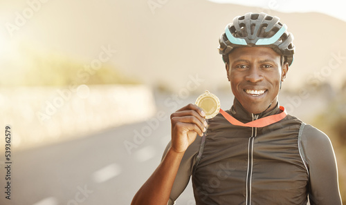 Cycling, marathon winner and gold medal by happy man holding, showing and celebrate success in road. Win, celebration and portrait of cyclist excited about fitness, health and endurance competition