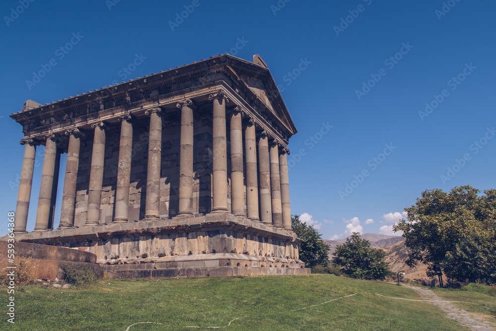 Temple of Garni in Armenia picturesque photo with the blue sky in the background and no people around. Ruins of ancient Armenian temple. Armenia landscape attraction.