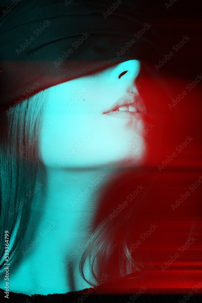 Obraz premium Beauty, sensual, make-up concept. Close-up studio shot of beautiful woman face covered with black ribbon in red and blue color split effect. Black and white image. Futuristic looking style