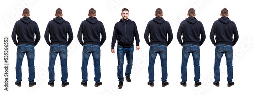 Lots of standing men in jeans and a blue hoodie. Back view. One handsome man steps out of their lines, front view. Isolated on white background. panorama format.