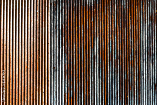 Artistic of old and rusty zinc sheet wall. Vintage style metal sheet roof texture. Pattern of old metal sheet. Rusting metal or siding. Corrosion of galvanized. Background and texture in retro concept