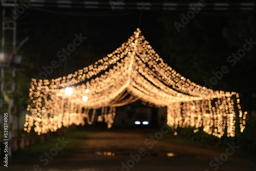 illuminated light bokeh decorations to form a arch at night © jayanthi photography