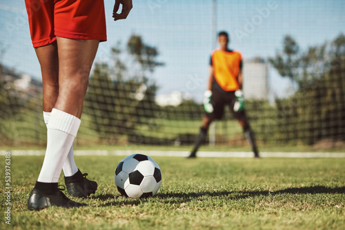 Sports, soccer field and legs of athlete with goalkeeper ready for penalty kick, game or competition for fitness health. Football player, ball or man prepare for outdoor workout, training or exercise photo
