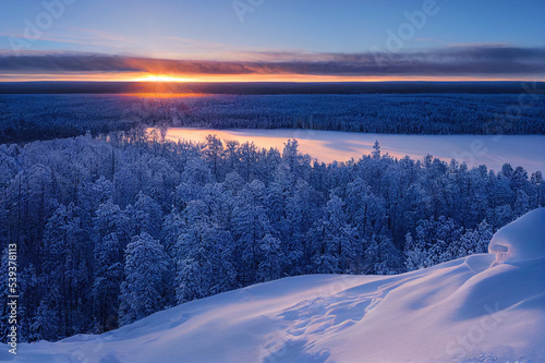 Winter wonderland in Finnish Lapland. Winter holiday in winter wonderland. Winter landscape sunset.