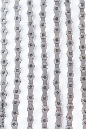 Closeup Background Texture of New Oiled Roller Bicycle Chain Taken from Top View.
