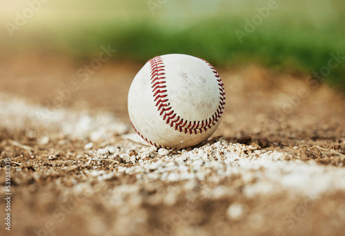Baseball, sports and sport field on grass in nature on a outdoor training court. White ball on the ground for exercise, cardio training and fitness workout of player and athlete team game on a field
