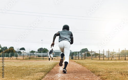Baseball player, running and sports pitch with athlete with fast energy doing base run at game or match on a sport field. Fitness, exercise and training workout with sport runner male outdoor