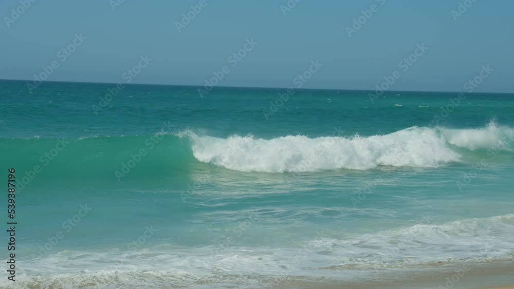 Waves run on the sandy shore of the sea. Sunlight reflect on water surface. beautiful evening nature sea background. Slow motion shot. Portugal. Waves run on the sandy shore of the sea. Sunlight reflect on water surface. beautiful evening nature sea background. Slow motion shot. Portugal.