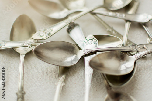 Obraz na płótnie Rustic and silver-plated spoons scattered on the table