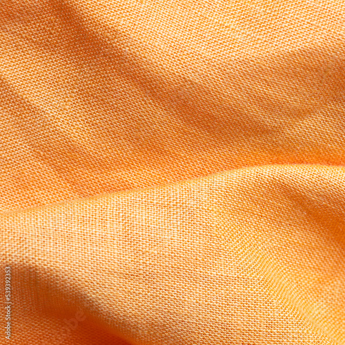 Close up of linen fabric texture in bright orange color. Eco friendly fabric background