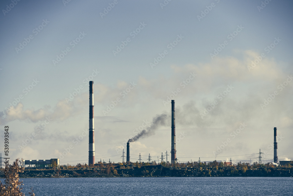Industrial landscape with heavy pollution produced by a large factory. Industrial landscape with heavy pollution produced by a large factory.