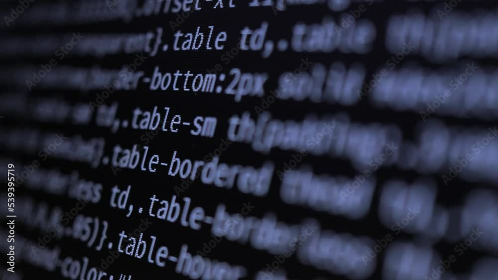 4K Close-up shot programming tag code on PC Monitor scroll down. Background concept for programming and coding web development. Side view, macro static shot. White letters on the screen.