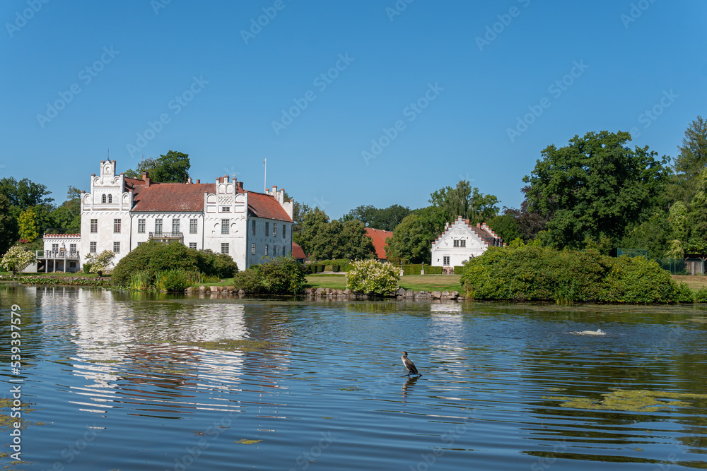 Sweden, Wanas – August 14, 2022: A beautiful ancient castle in front of a lake on a sunny summer day 