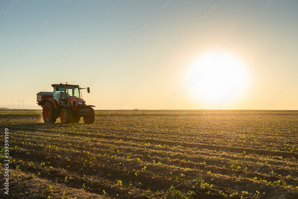 Tractor spreading artificial fertilizers Tractor spreading artificial fertilizers