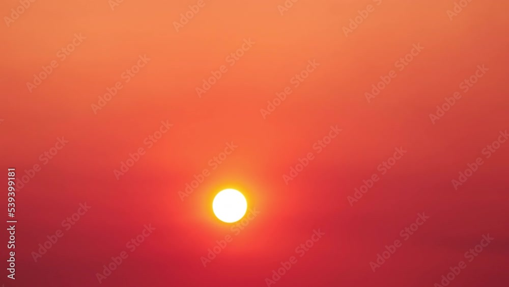 A big red sun in the sunset sky, a summer landscape. Evening sky in hot sunlight A big red sun in the sunset sky, a summer landscape. Evening sky in hot sunlight