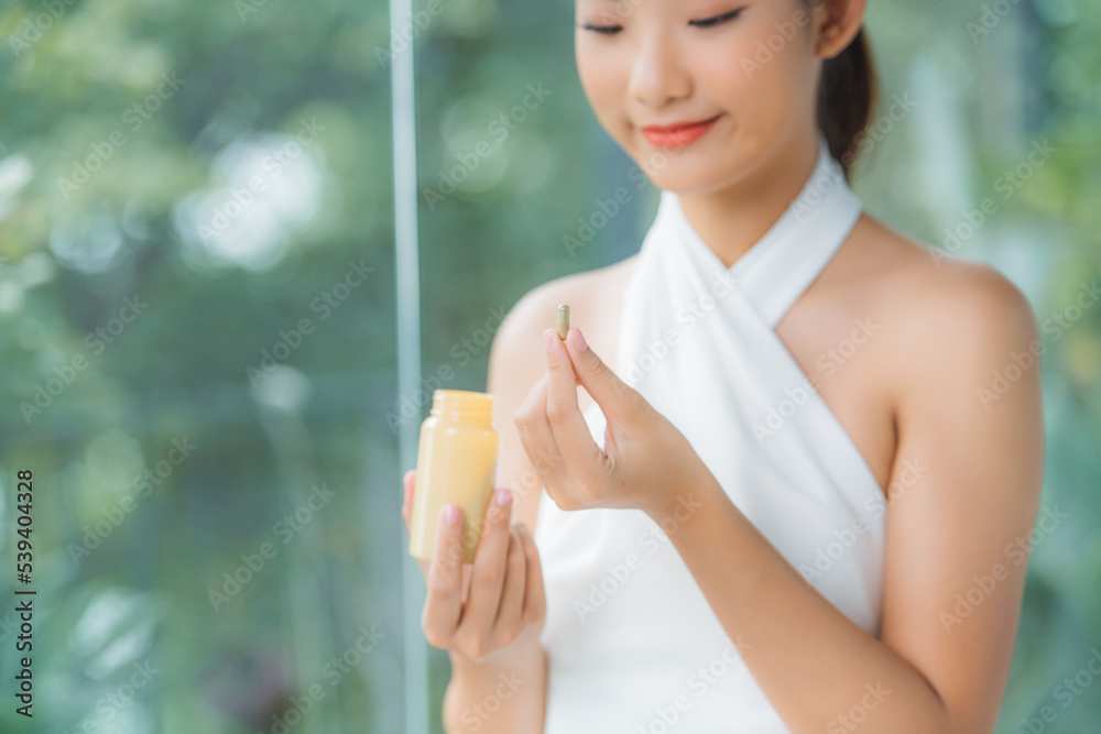 Beautiful Smiling Girl Taking Medication, Holding Bottle With Pills In Hand. Beautiful Smiling Girl Taking Medication, Holding Bottle With Pills In Hand.