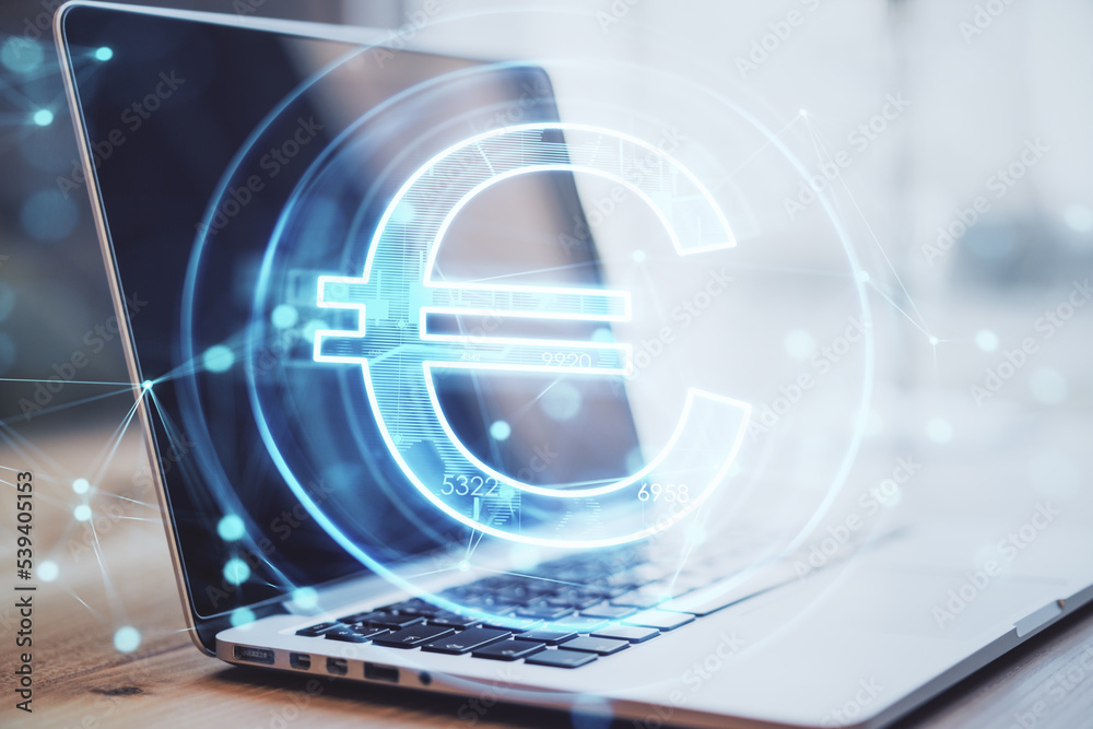 Close up of laptop with creative glowing euro hologram on blurry backround. Futuristic hi-tech digital money and electronic economy of the future concept. Double exposure. Close up of laptop with creative glowing euro hologram on blurry backround. Futuristic hi-tech digital money and electronic economy of the future concept. Double exposure.