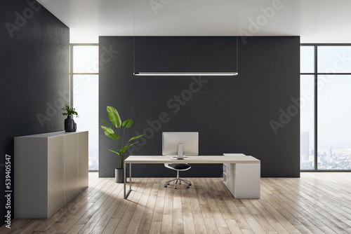 Front view on modern computer on style light table in minimalistic office interior design with wooden floor  city view from big window and black wall background. 3D rendering