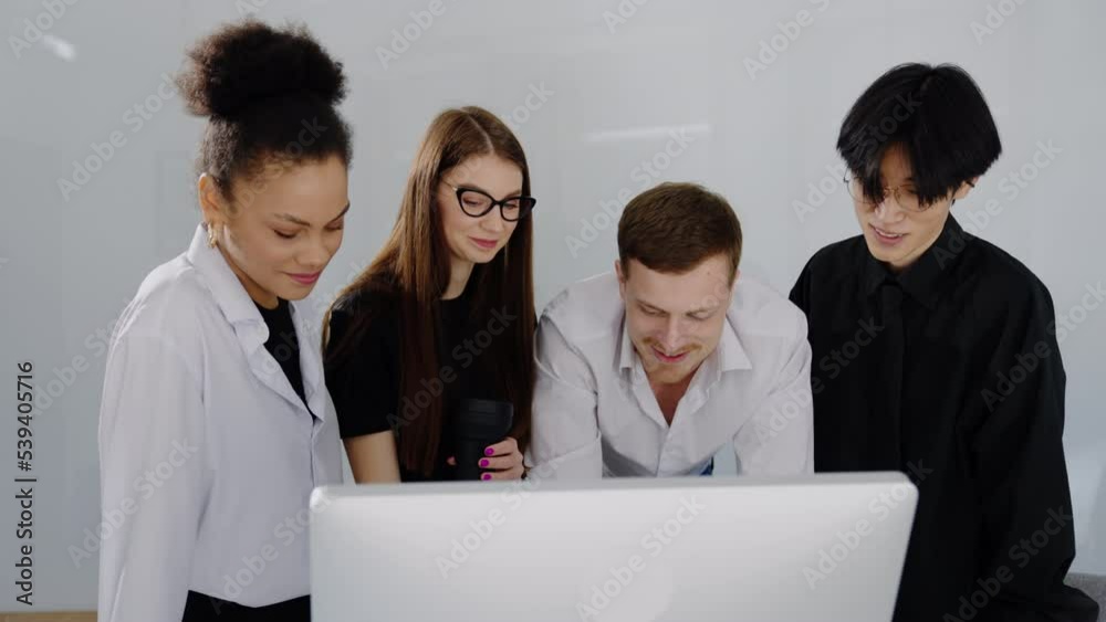 A team of four people working on a new project in the office A team of four people working on a new project in the office
