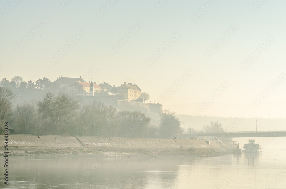 Petrovaradin fortress in the autumn period of the year. A view of the Petrovaradin fortress and the Danube river, covered with autumn mist.