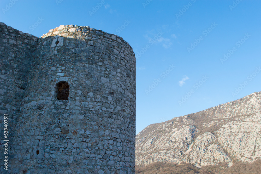 Medieval stone tower with small window, on the hill in Drivenik, Croatia