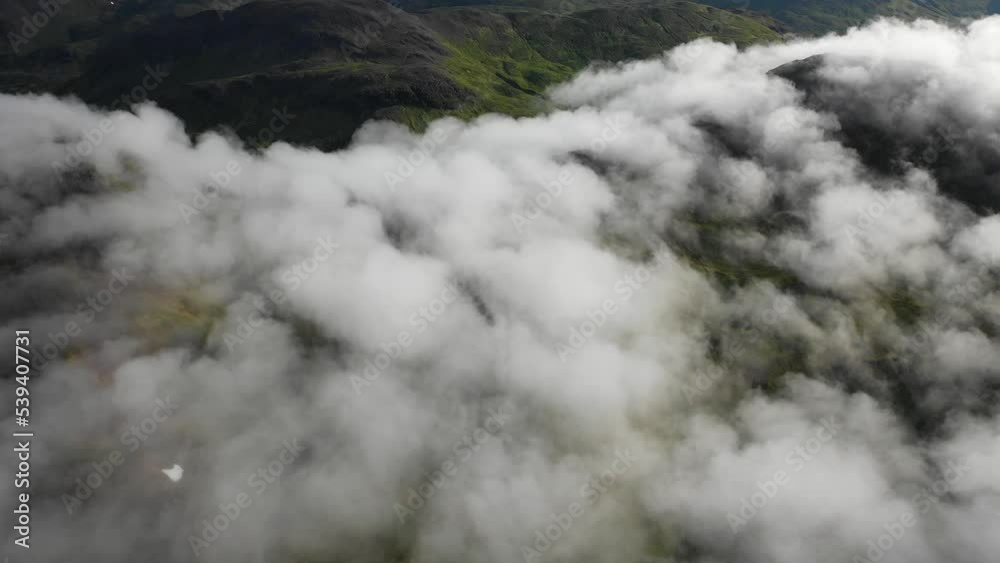 Aerial view of mountains peaks with low clouds, Unalaska island, Alaska, United States. Aerial view of mountains peaks with low clouds, Unalaska island, Alaska, United States.