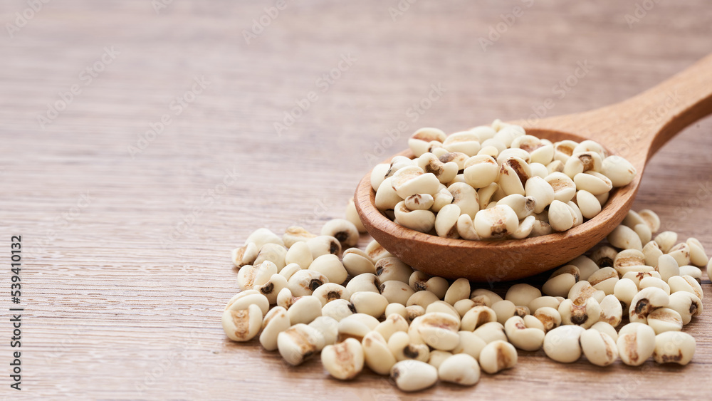 Jobs tear seed or coix millet seed grain in wood spoon on wooden table kitchen background. heap of Jobs tear or coix millet seed grain. Jobs tear or millet coix seed Jobs tear seed or coix millet seed grain in wood spoon on wooden table kitchen background. heap of Jobs tear or coix millet seed grain. Jobs tear or millet coix seed