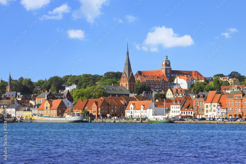 The historical port of Flensburg and the St. Mary's church and the old town in background, Germany