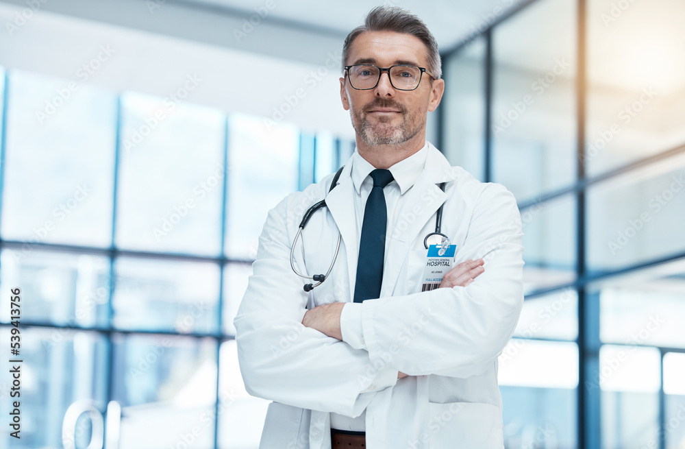 Doctor, senior man and arms crossed with glasses and stethoscope in medical healthcare clinic. Health medic research expert, science innovation leader and proud professional surgeon in hospital Doctor, senior man and arms crossed with glasses and stethoscope in medical healthcare clinic. Health medic research expert, science innovation leader and proud professional surgeon in hospital