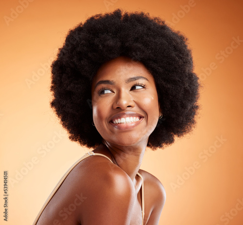 Black woman, african beauty and skincare health of luxury spa model with a smile on an orange studio background. Natural skin, healthy face and happy casual organic cosmetic afro hair treatment model photo