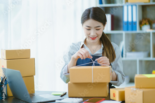Asian teenager owner business woman work at home for online shopping and sale. © Kritdanai