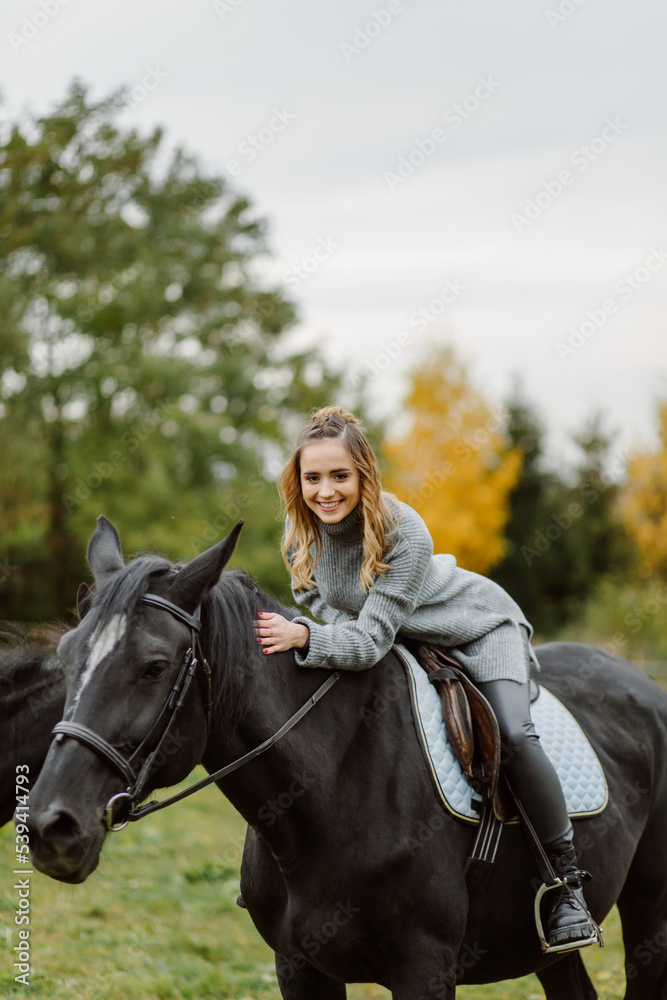 Woman on a horse at rancho. Horse riding, hobby time. Concept of animals and human Woman on a horse at rancho. Horse riding, hobby time. Concept of animals and human