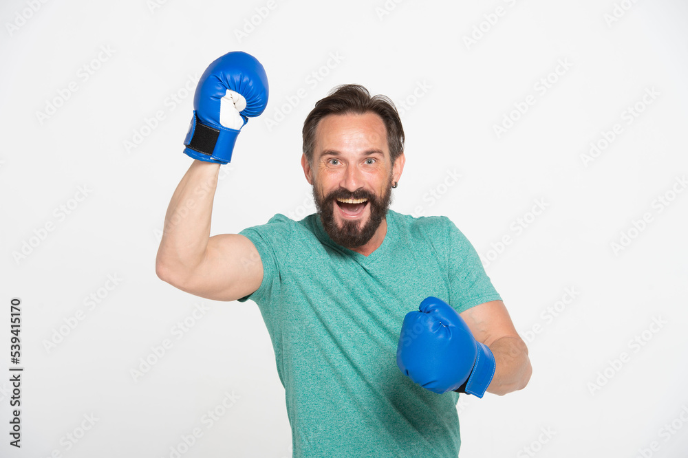 excited cheerful middle-aged bearded man celebrating success and wearing boxing gloves isolated on white background excited cheerful middle-aged bearded man celebrating success and wearing boxing gloves isolated on white background