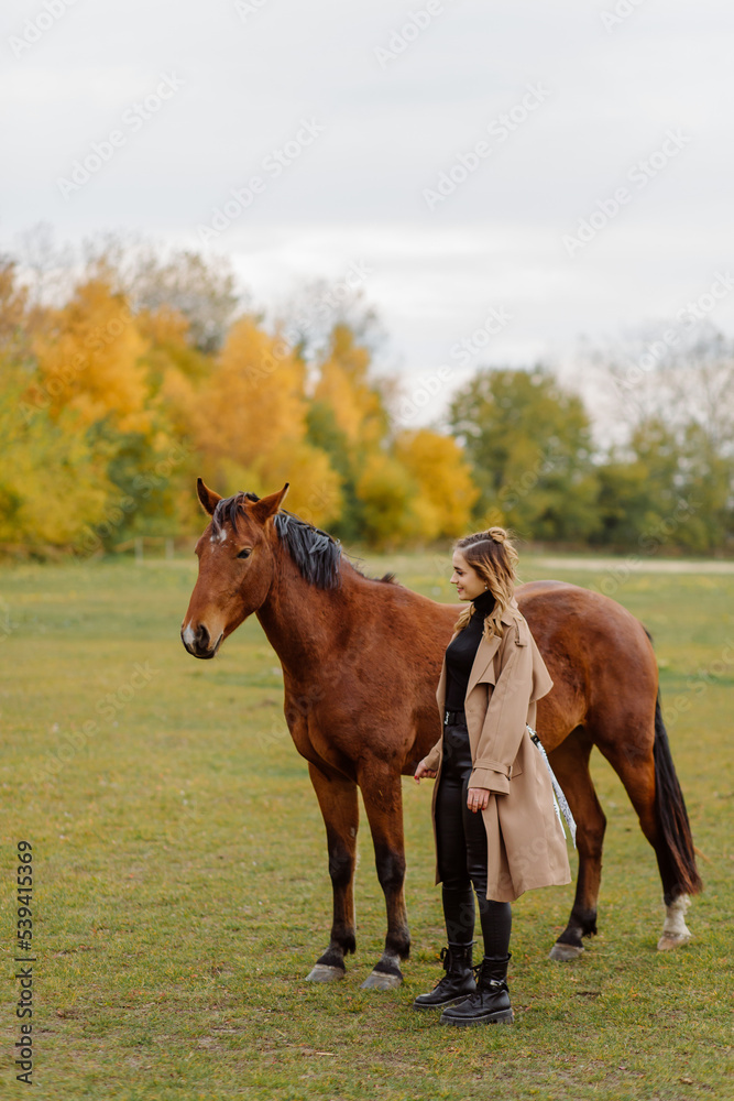 Fototapeta premium Woman on a horse at rancho. Horse riding, hobby time. Concept of animals and human