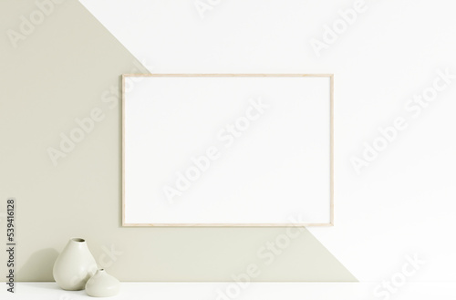 Clean and minimalist front view horizontal wooden photo or poster frame mockup hanging on the wall with vase. 3d rendering.