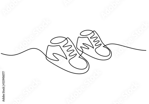 One continuous single line of baby shoes isolated on white background.