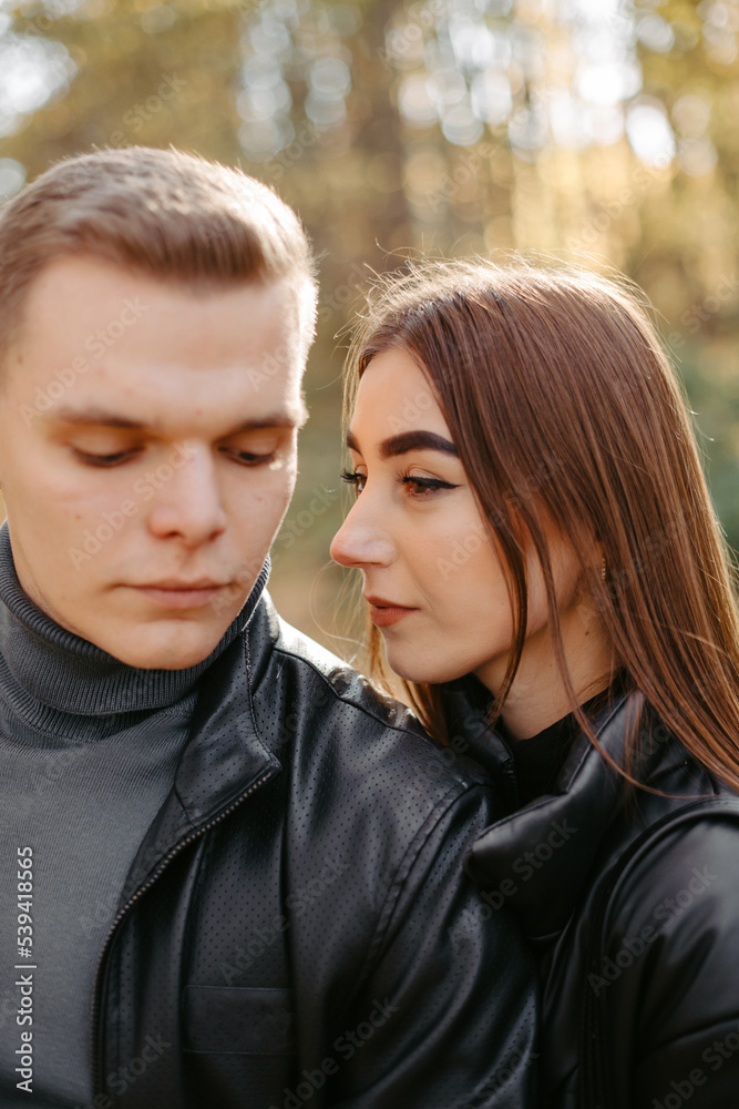 Lovely couple posing in autumn forest, lovers walking in park. lovestory in forest Lovely couple posing in autumn forest, lovers walking in park. lovestory in forest