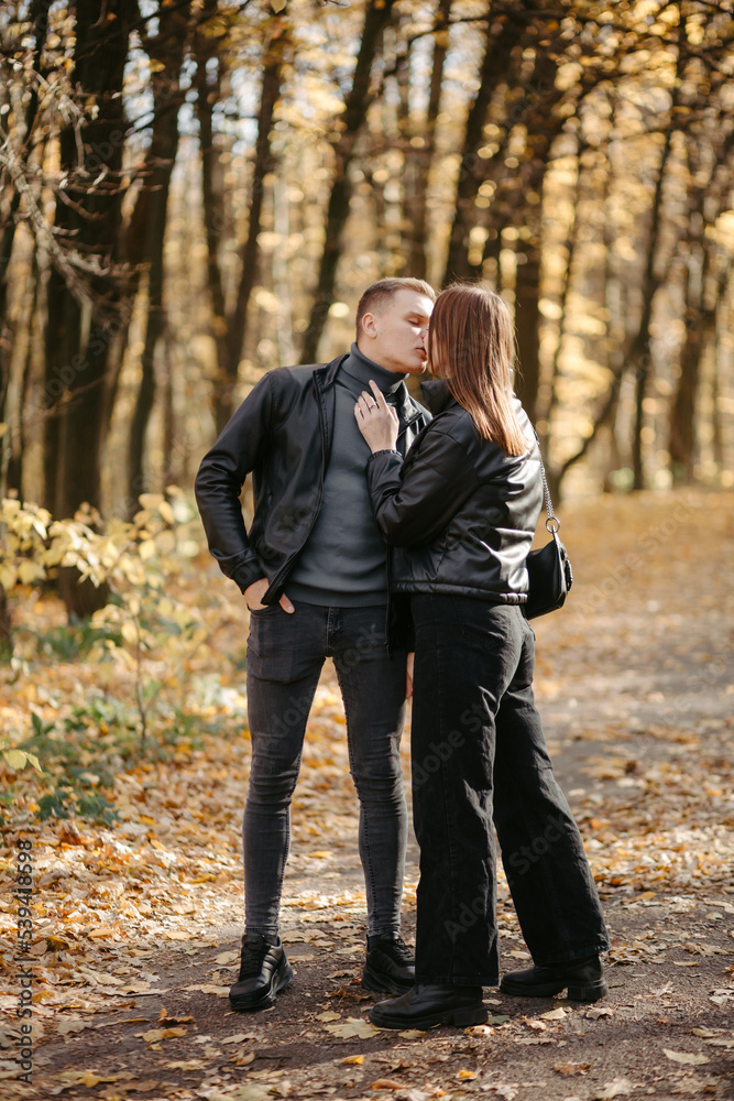 Lovely couple posing in autumn forest, lovers walking in park. lovestory in forest Lovely couple posing in autumn forest, lovers walking in park. lovestory in forest