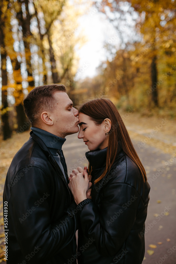 Lovely couple posing in autumn forest, lovers walking in park. lovestory in forest