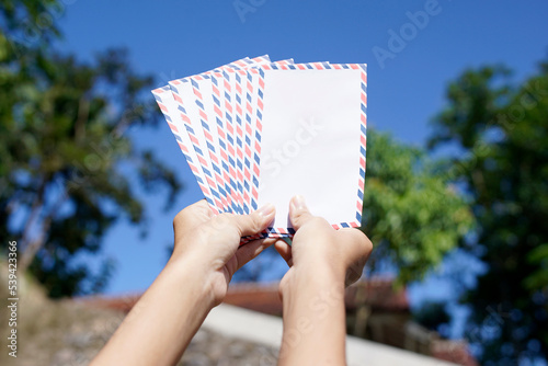 woman shows the envelope to be distributed on the day of Eid