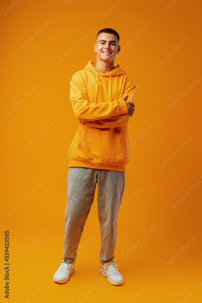 Full length portrait of young man standing on yellow background Full length portrait of young man standing on yellow background