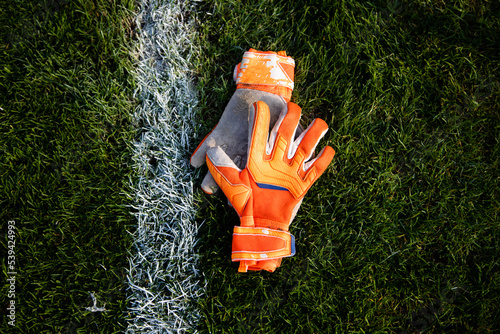Goalkeeper gloves lay on the soccer field photo