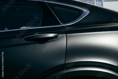 side part of black matte luxury car © Hanna